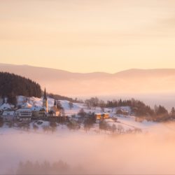 Foggy winter pastel sunrise over Sörg, Carinthia, Austria