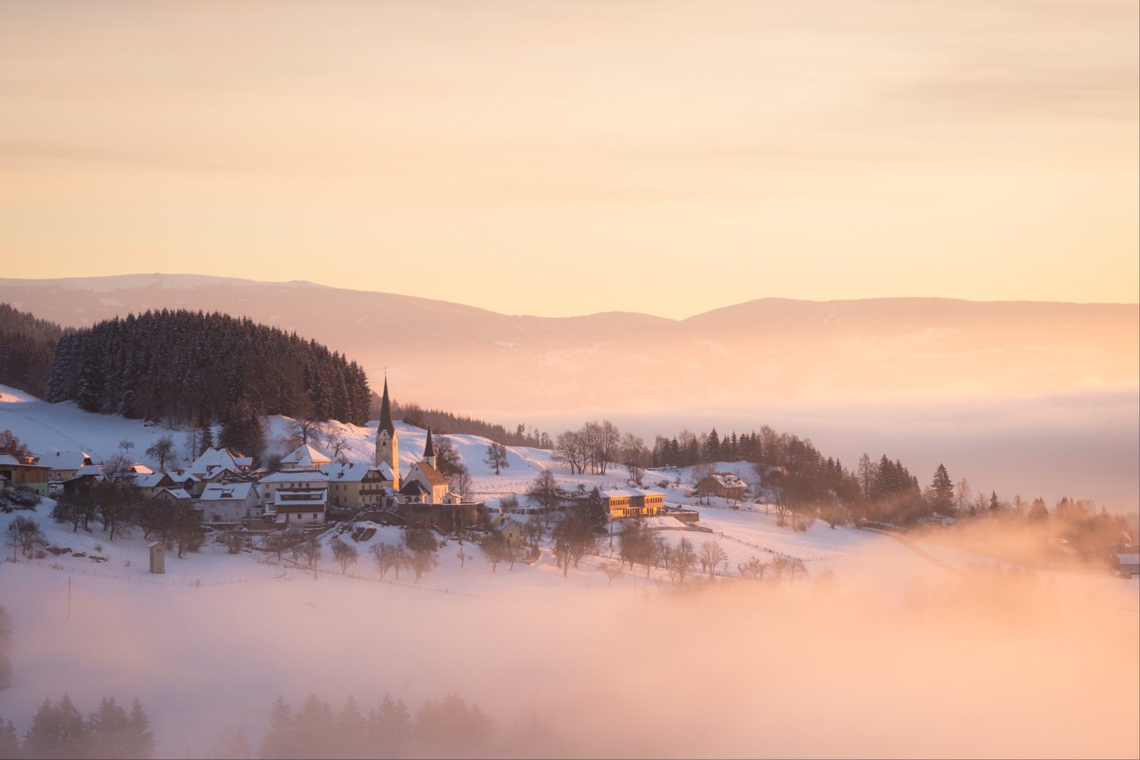 Foggy winter pastel sunrise over Sörg, Carinthia, Austria