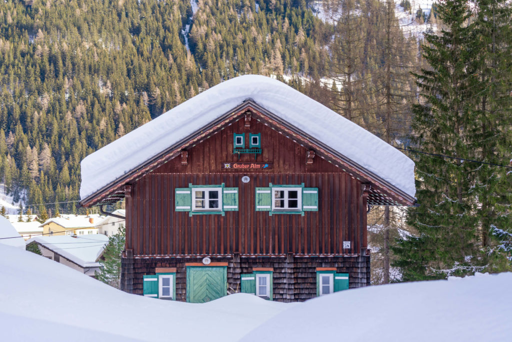 Gruber Alm, perfect wooden winter hut covered in snow, Mallnitz, Carinthia