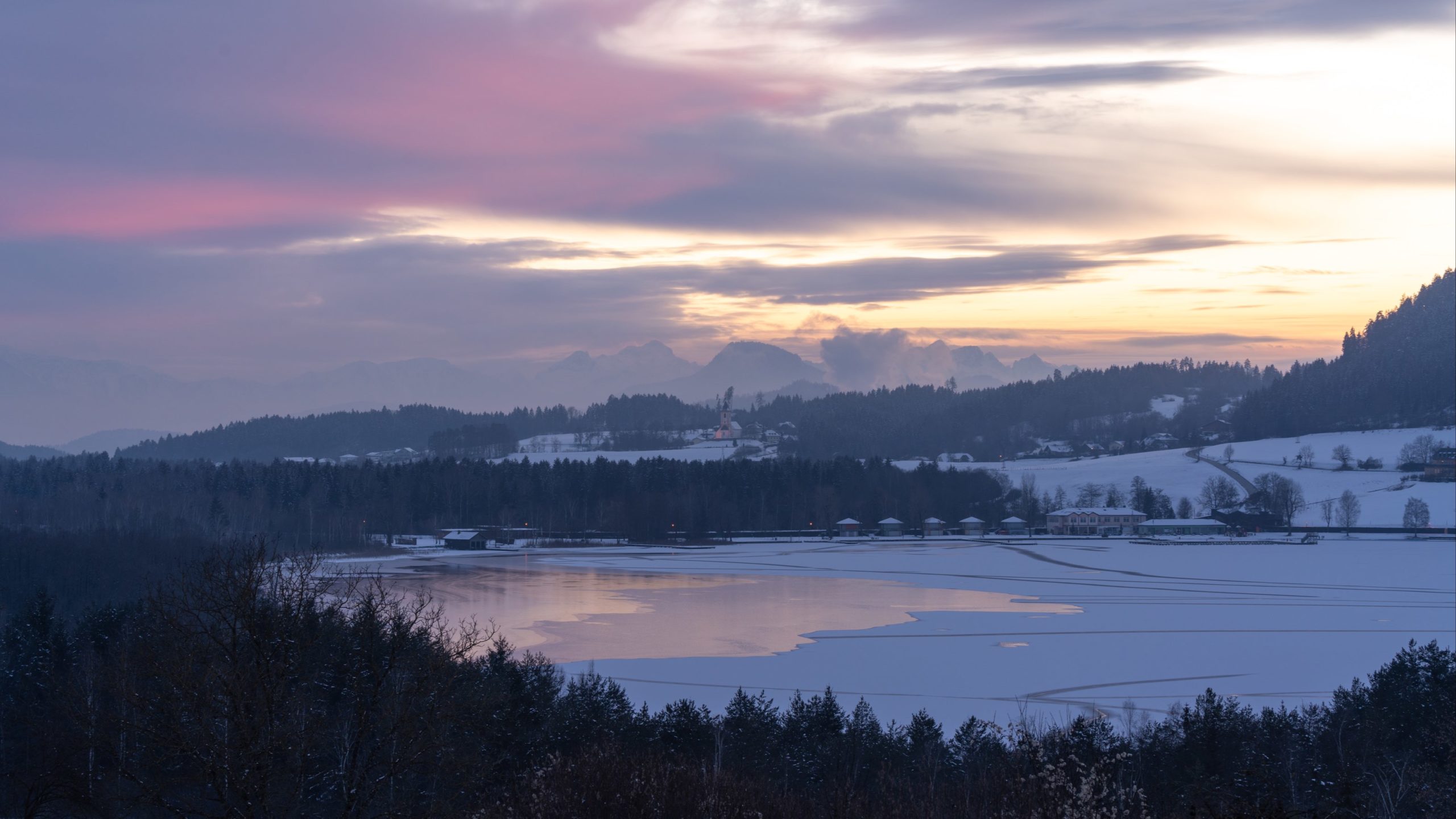 Längsee winter sunset with half frozen lake