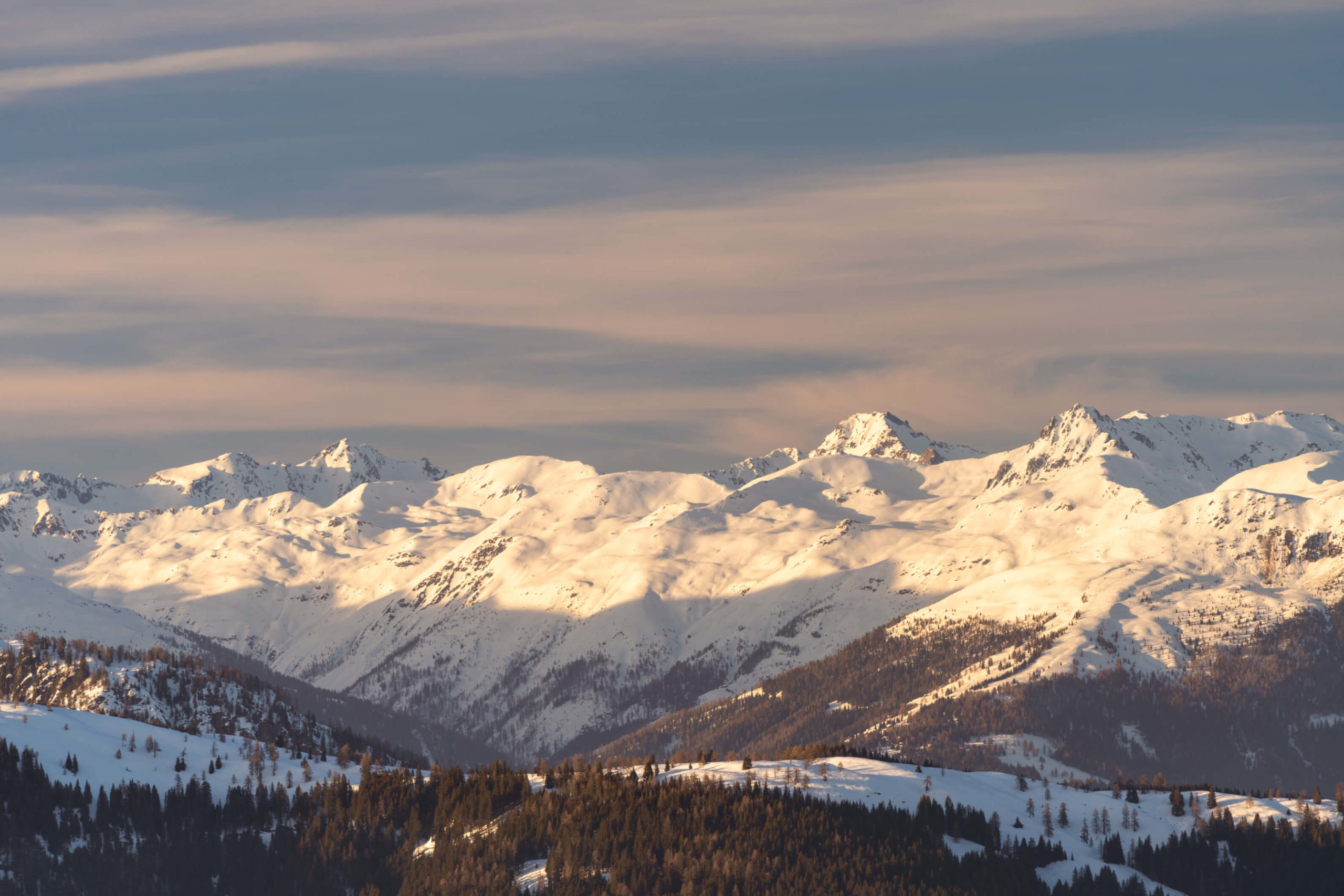 Snow covered peaks from Nassfeld lit up by warm light, Carinthia