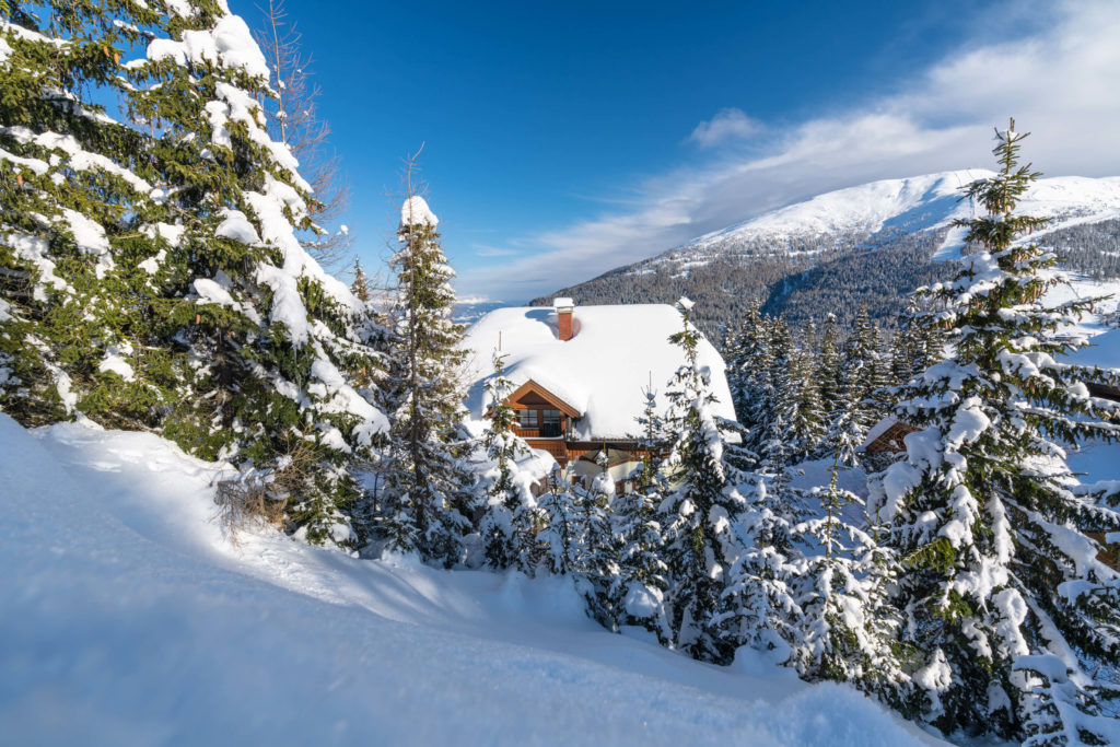 Snowy houses surrounded by pines in winter at Katschberg, Carinthia