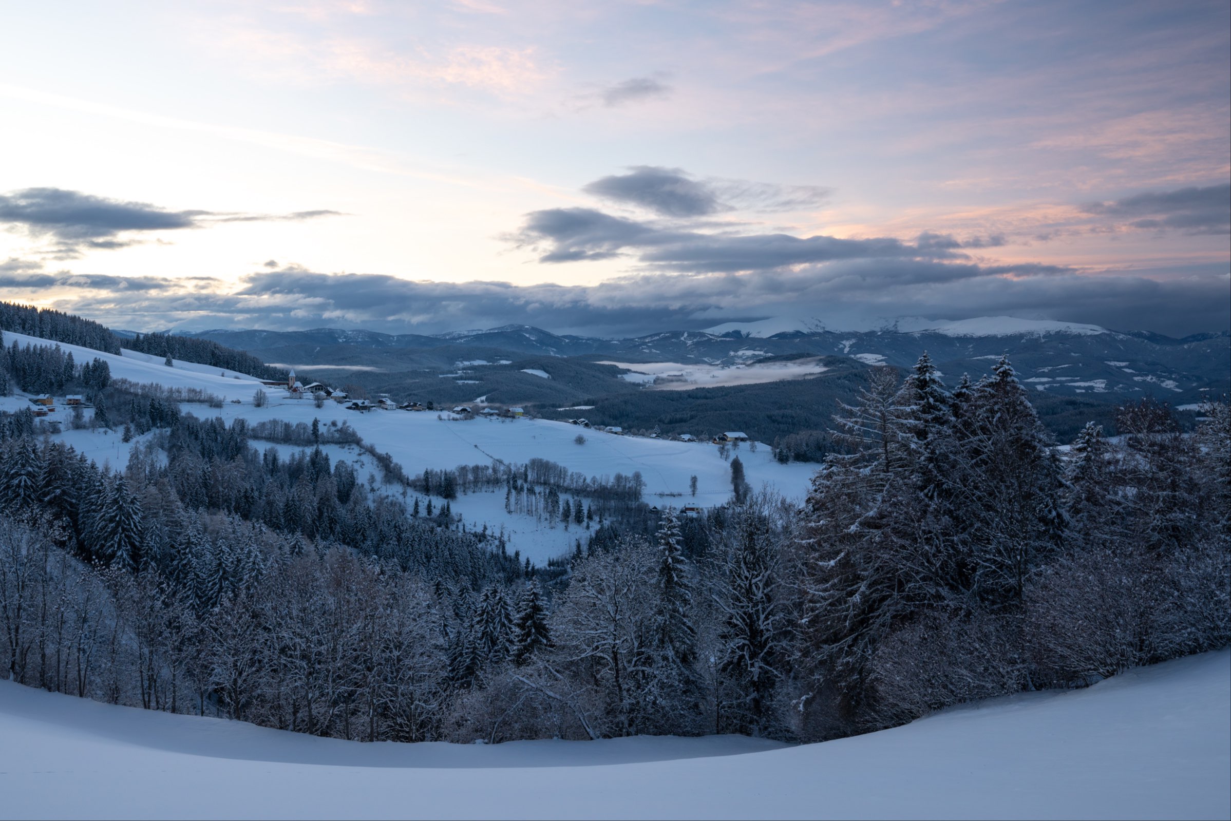 Steinbichl covered in thick snow at sunset, Carinthia, Austria