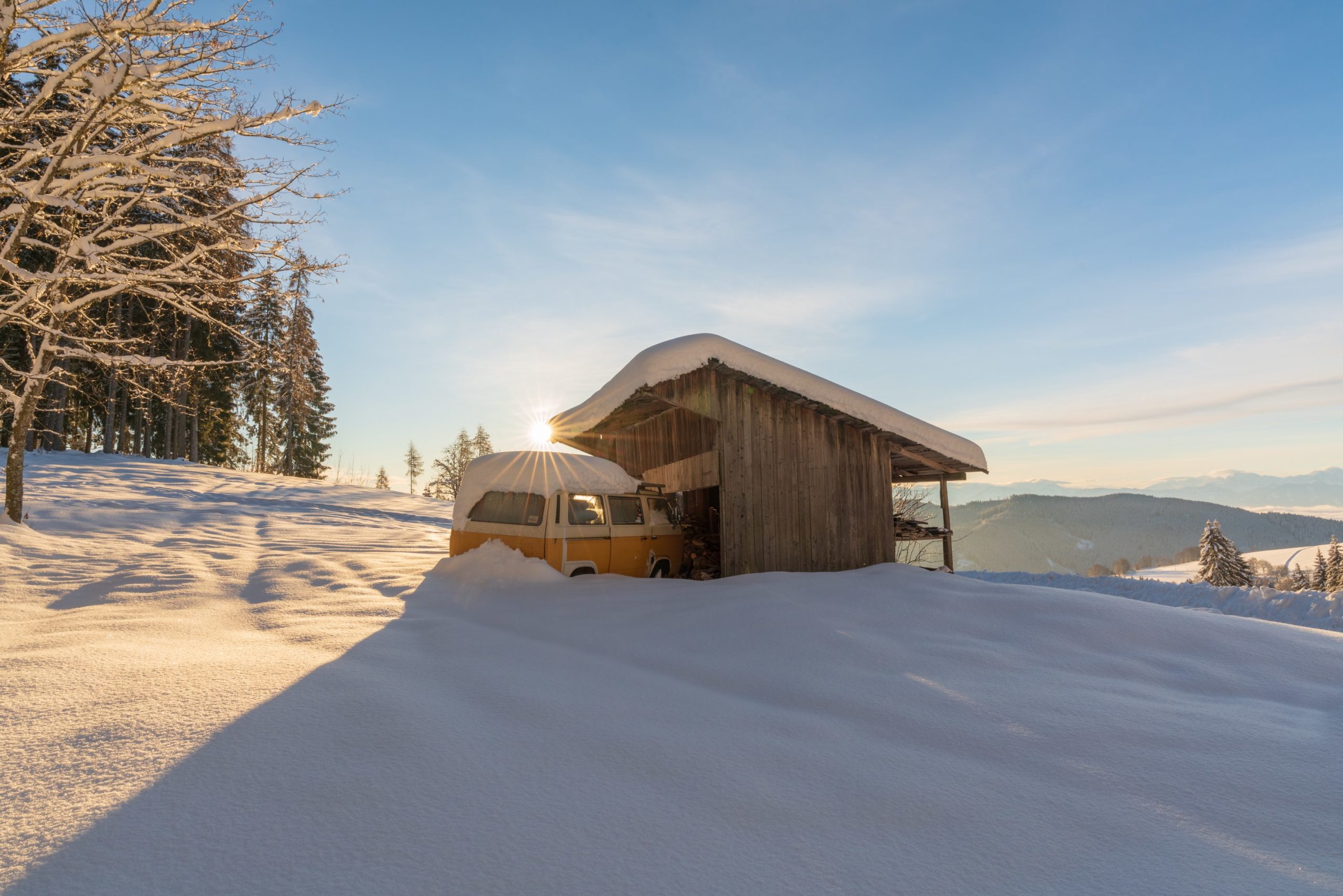 Sunrise over a classic VW camper covered in snow, Carinthia, Austria