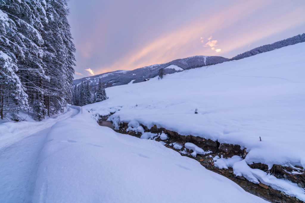 Sunset by the stream in the winter landscape of Bad Kleinkirchheim, Carinthia