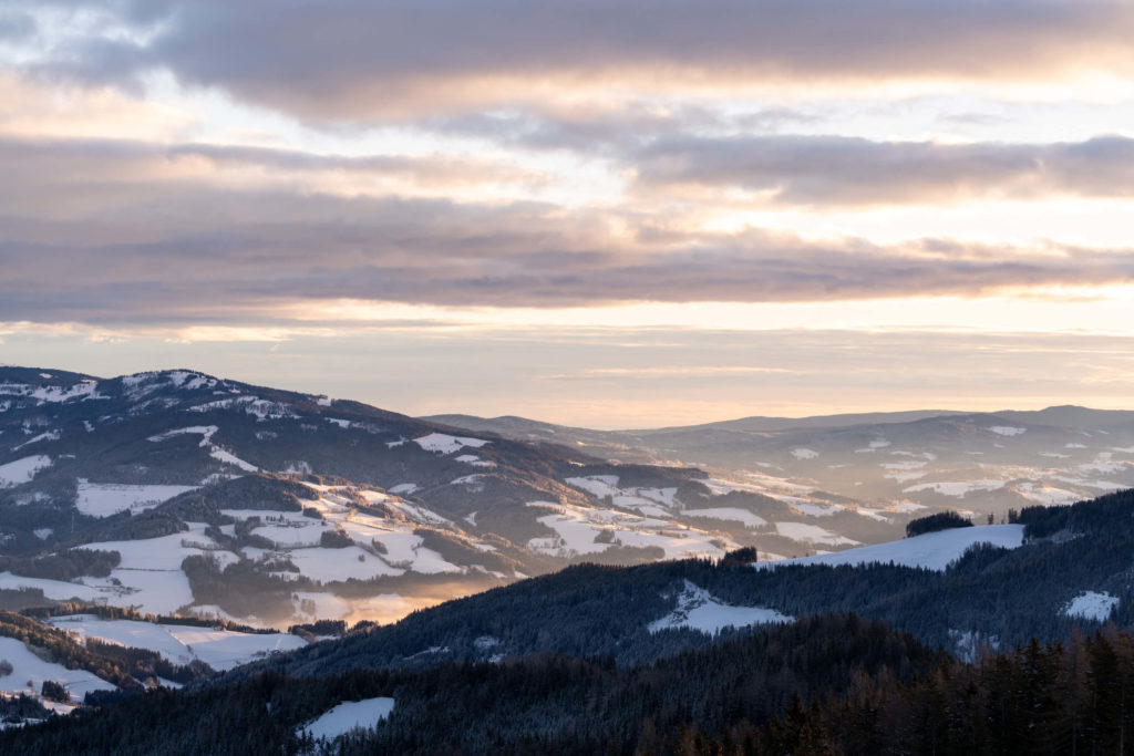 Winter sunrise over snow covered landscape from Klippitztörl, Carinthia