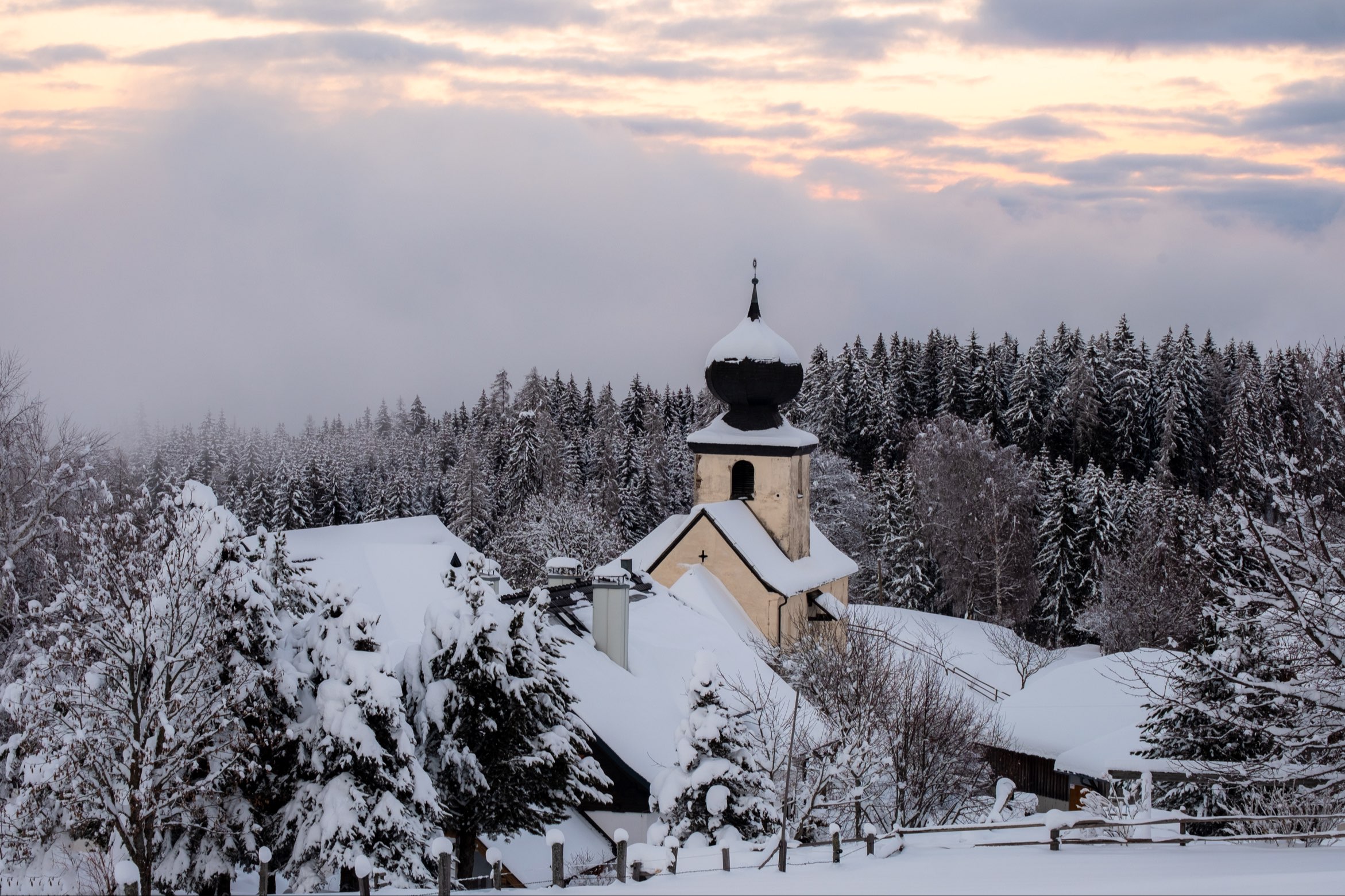 Winter sunset over Hoch St. Paul church, Carinthia, Austria