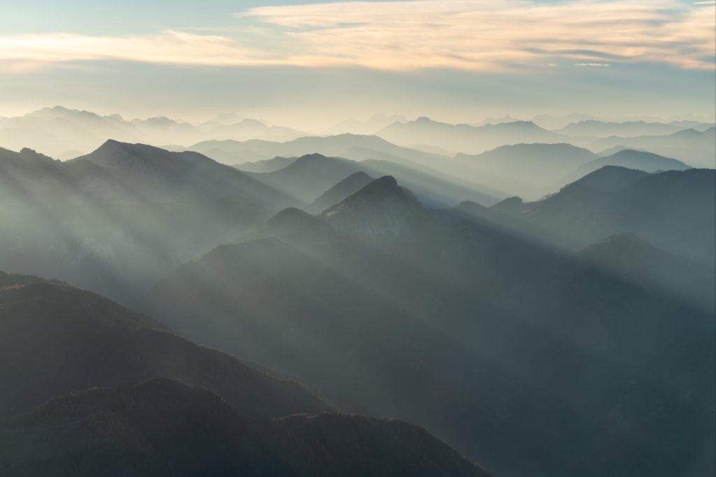 Diffused light during a sunset over the mountain peaks of Austria from Schneeberg during forest fires