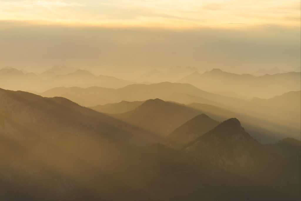 Layers of golden light over the many peaks from Schneeberg