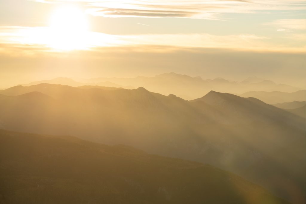 Layers of golden light over the many peaks from Schneeberg