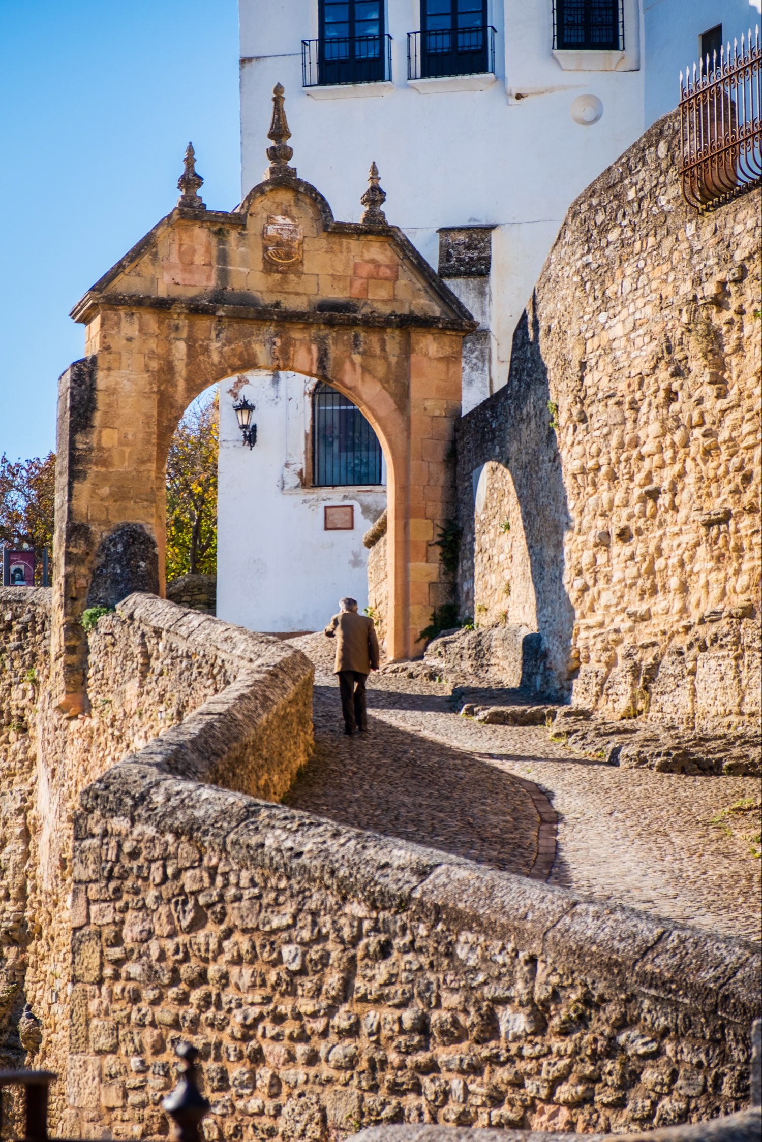 Man walking through Carlos V gate in Ronda