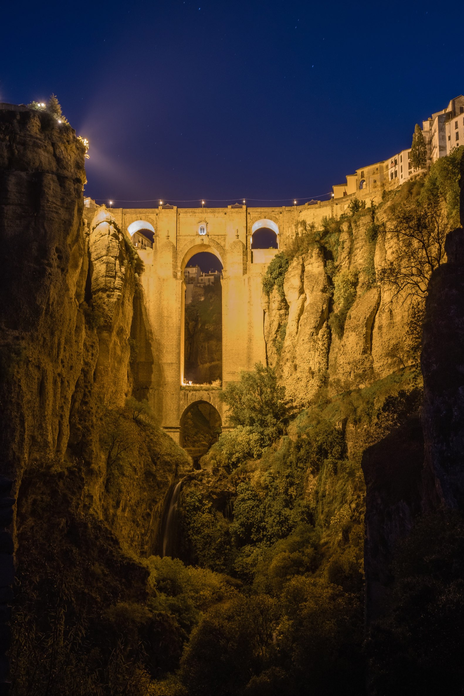 Puente Nuevo and waterfall at night from below, Ronda, Spain