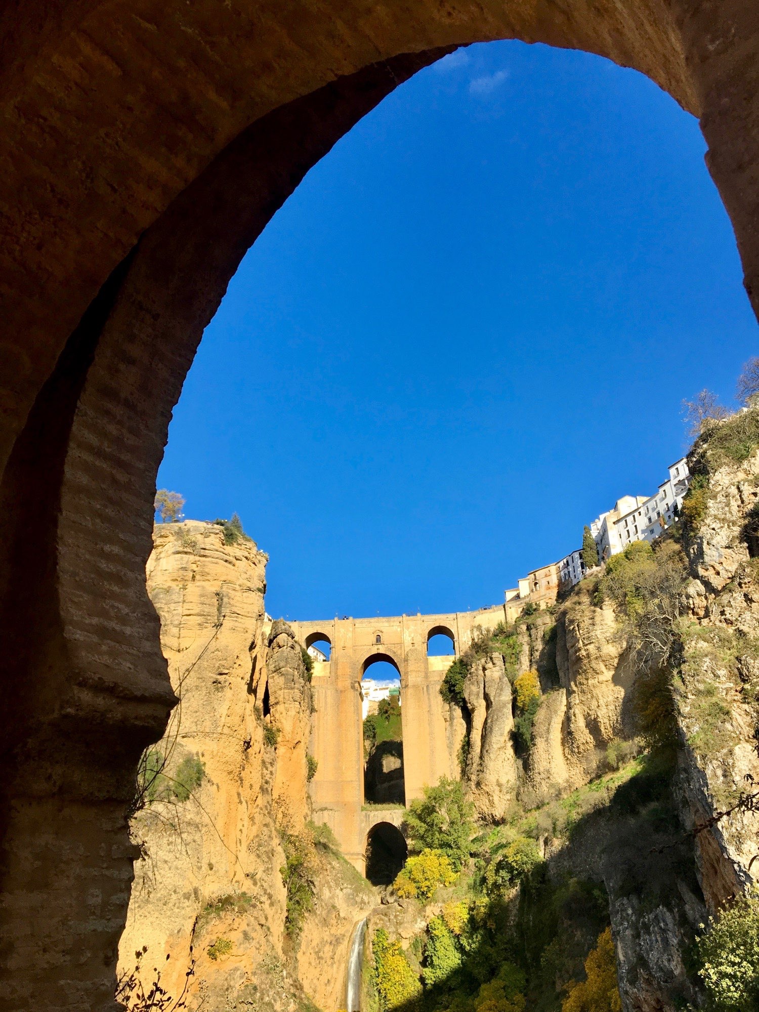 Puente Nuevo with waterfall through an arch