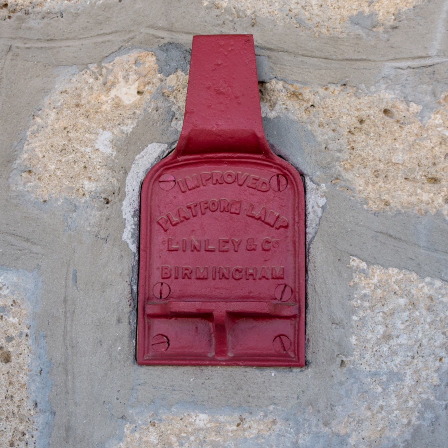 Red metal sign from Birmingham at Ronda train station