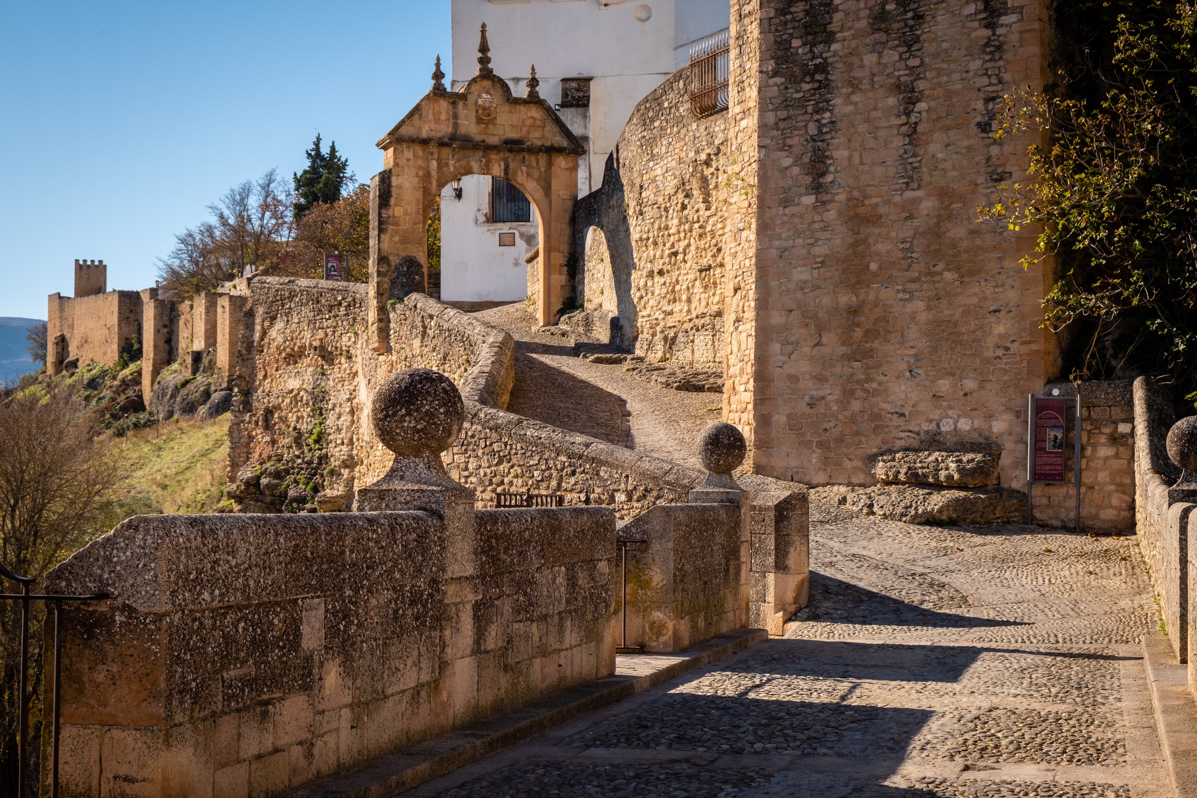 Wider view of Ronda city walls and Carlos V gate