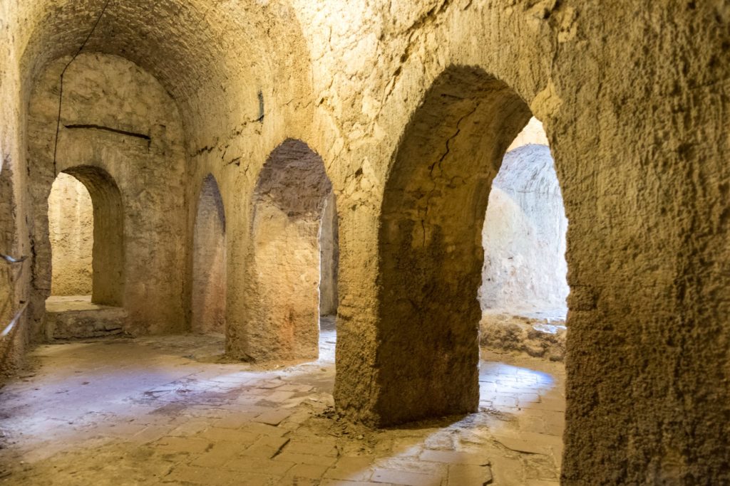 Stone chambers and arches inside La Casa del Rey Moro
