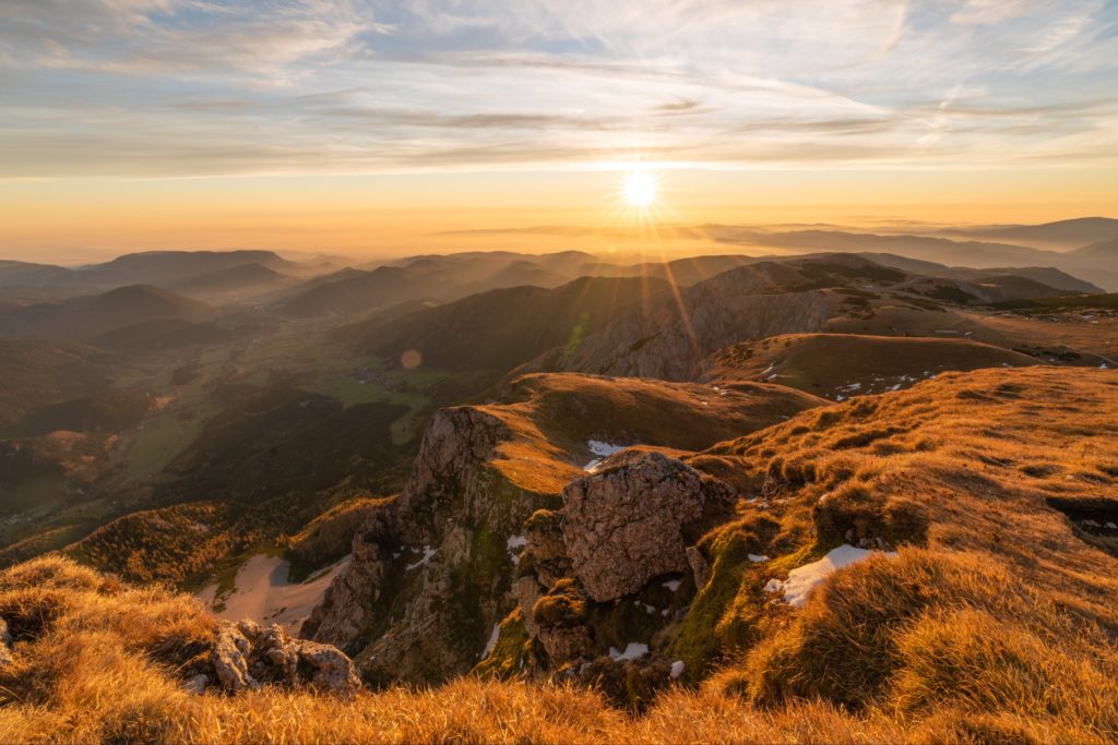 Sunrise views from Fischerhütte mountain hut with steep cliff edges smothered in warm light