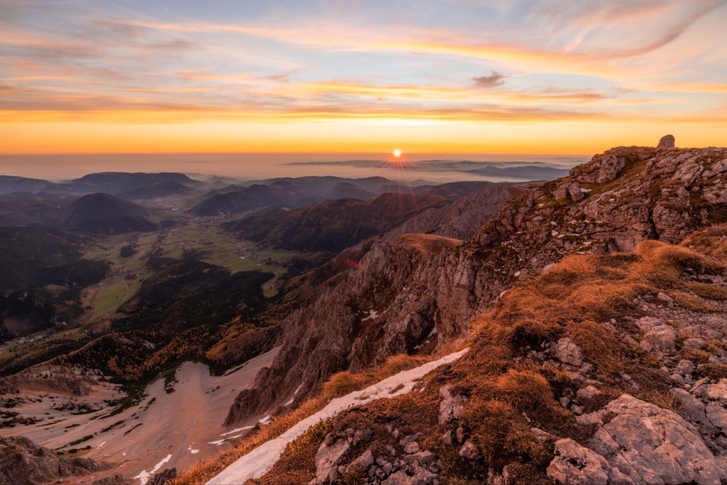 Vibrant autumn sunrise from the top of Schneeberg with steep cliffs