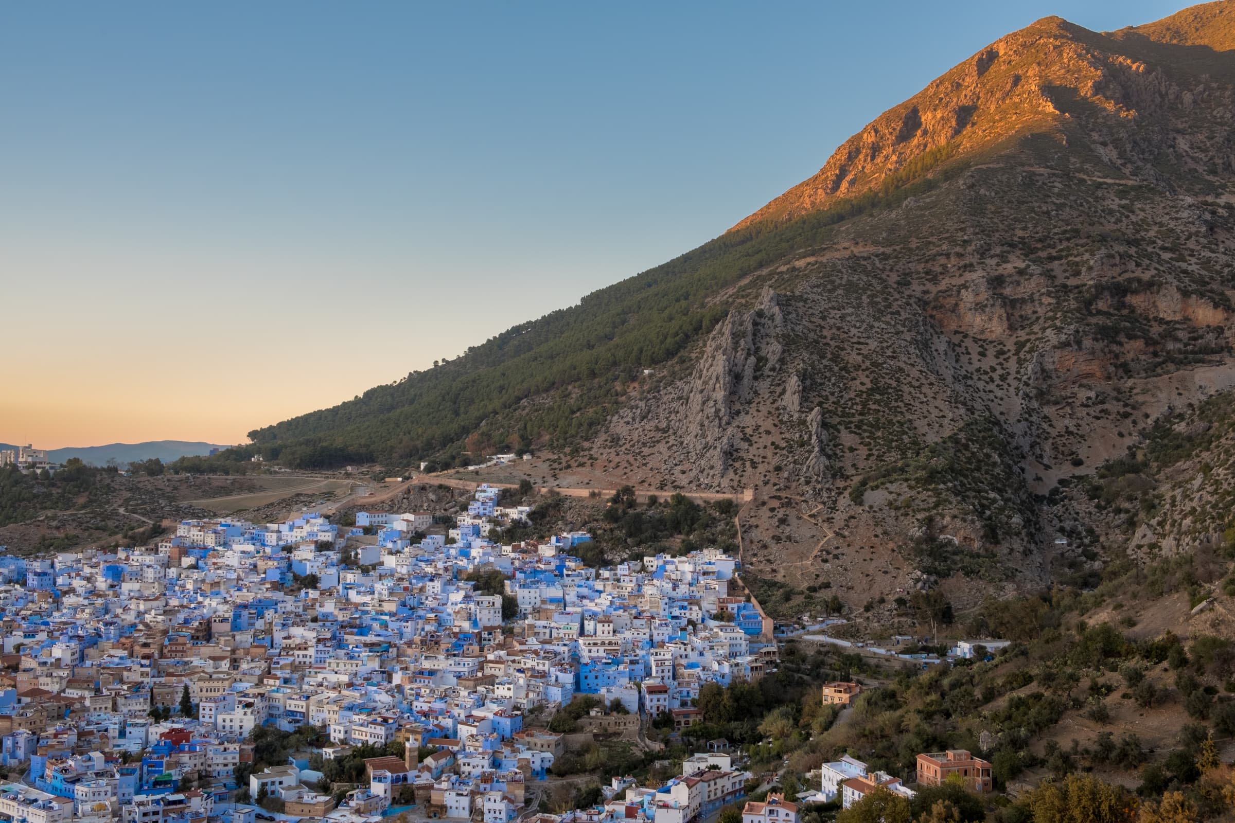 Sunset over Chefchaouen, Morocco from the Spanish Mosque with towering mountains behind