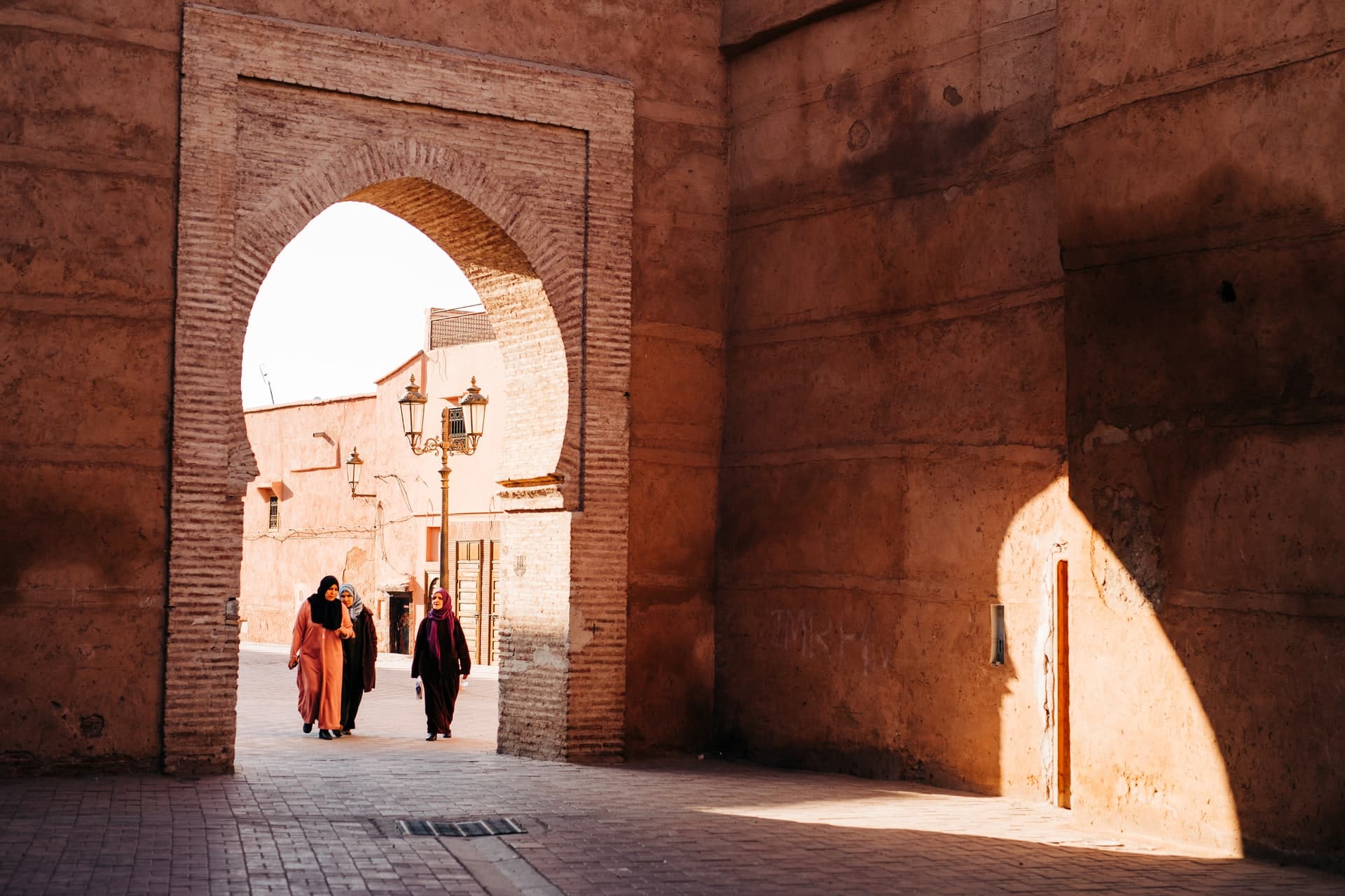 A city gate with women walking through