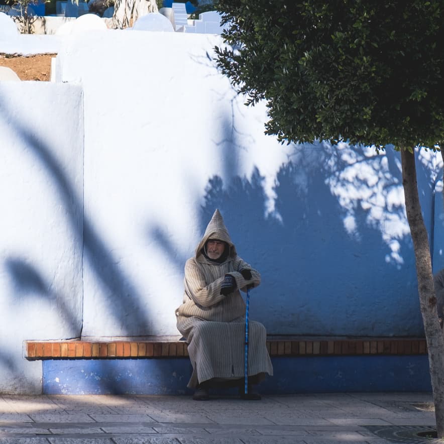 A man sitting in traditional Berber dress, Chefchaouen, Morocco