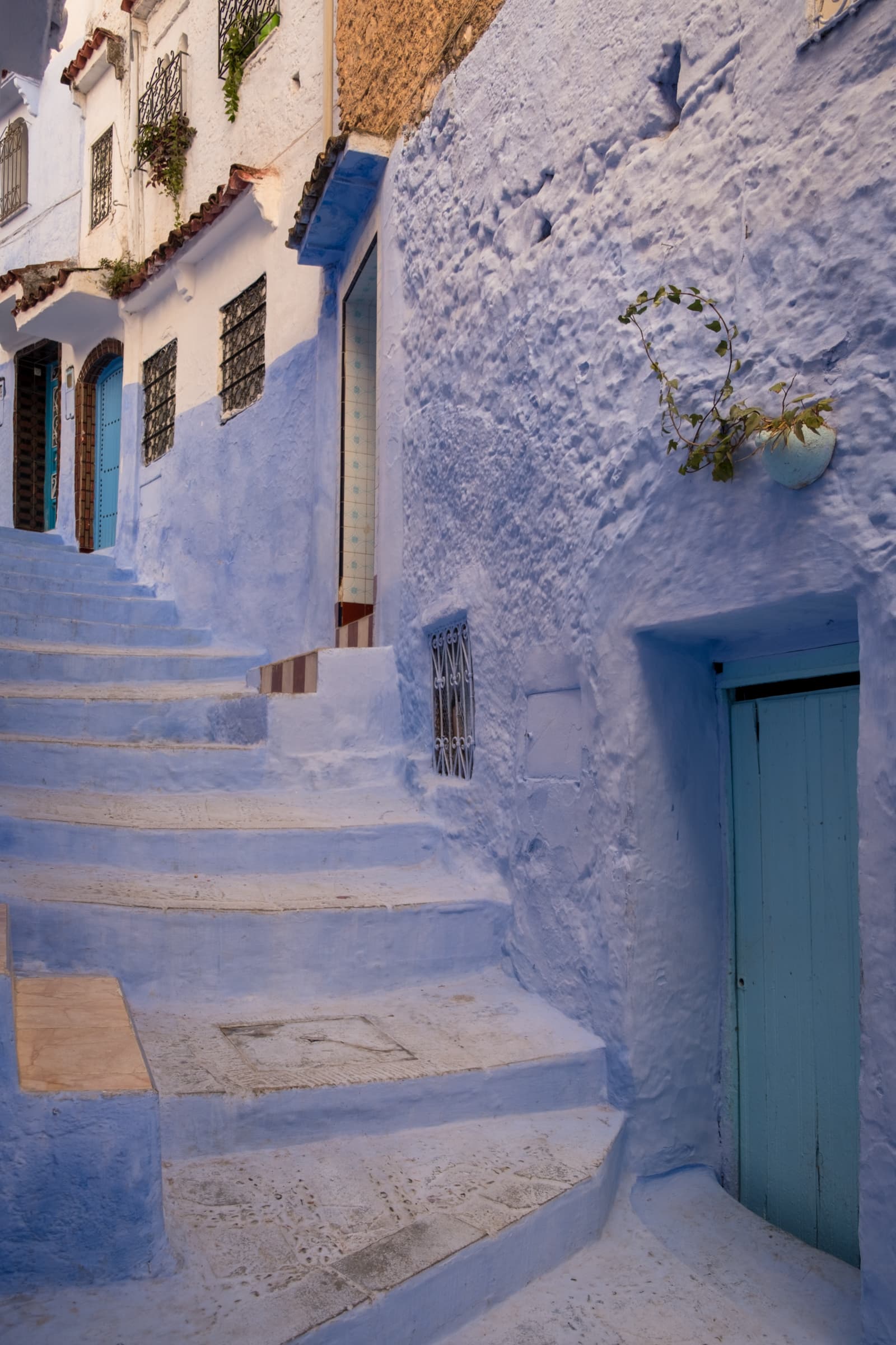 A steep blue side street in Chefchaouen, Morocco