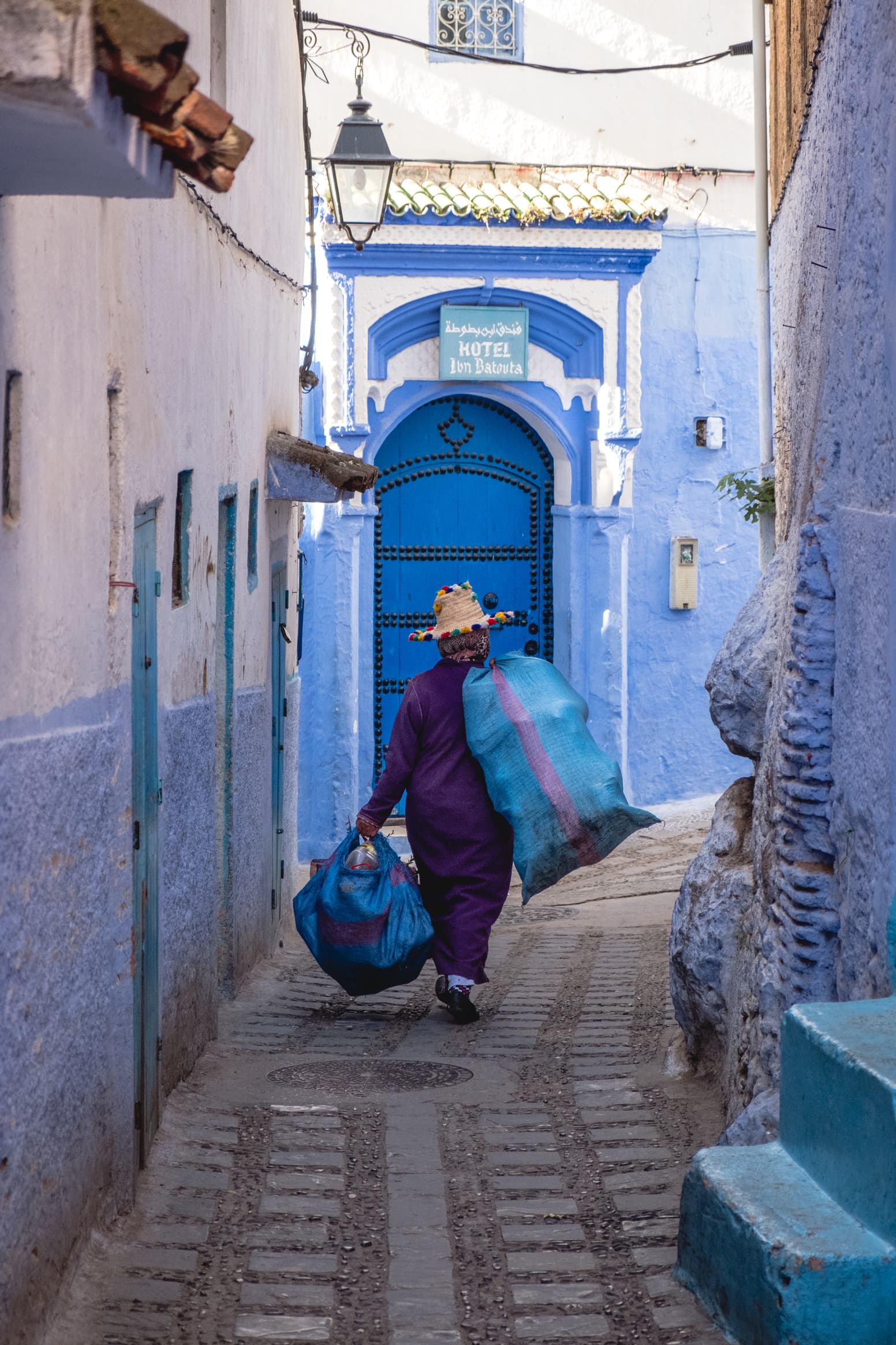 A working woman in traditional Berber dress, Chefchaouen, Morocco