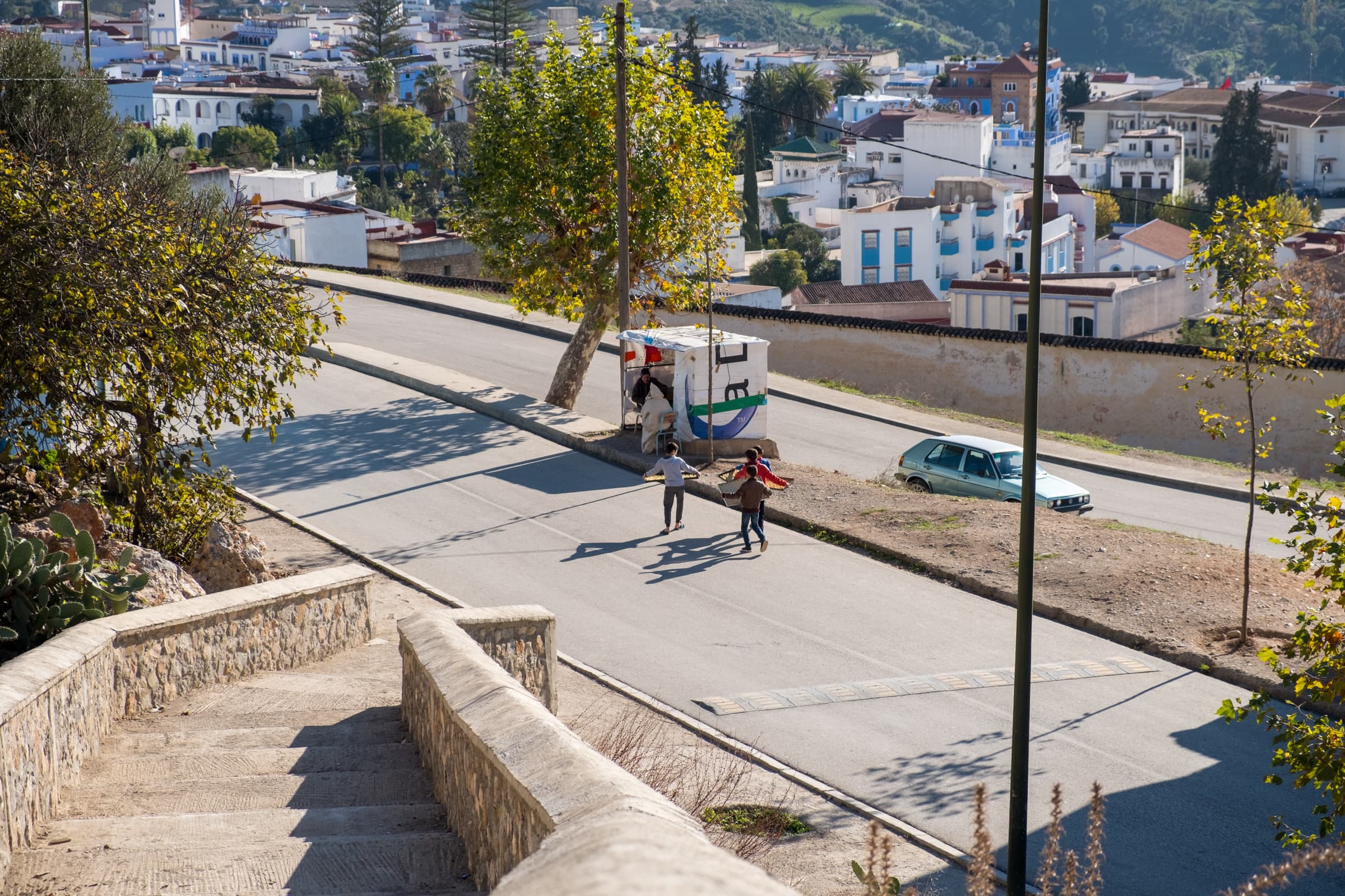 Boys delivering dough to a food stall, Chefchaouen, Morocco