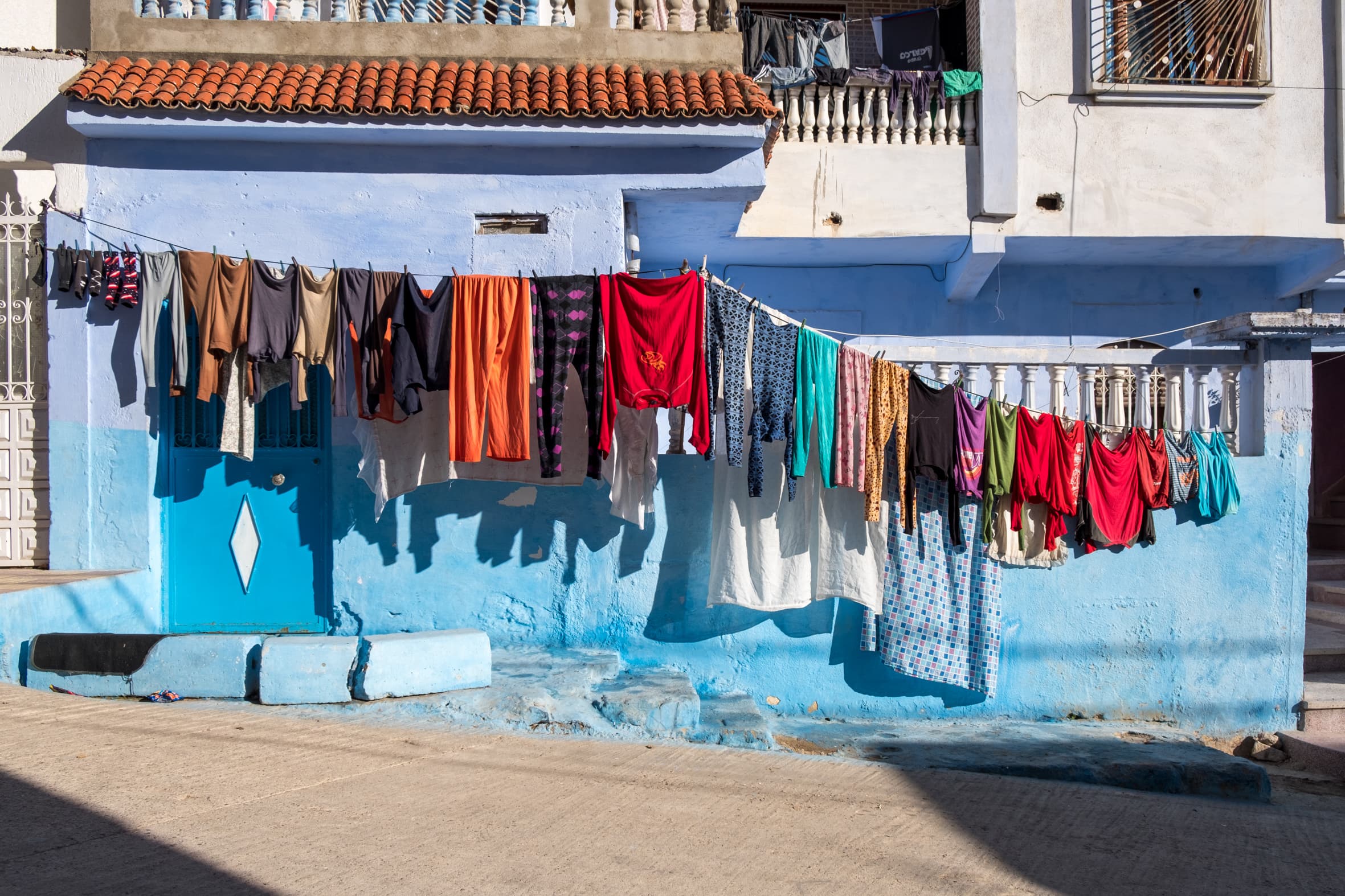 Clothes washing drying on a blue house, Chefchaouen, Morocco