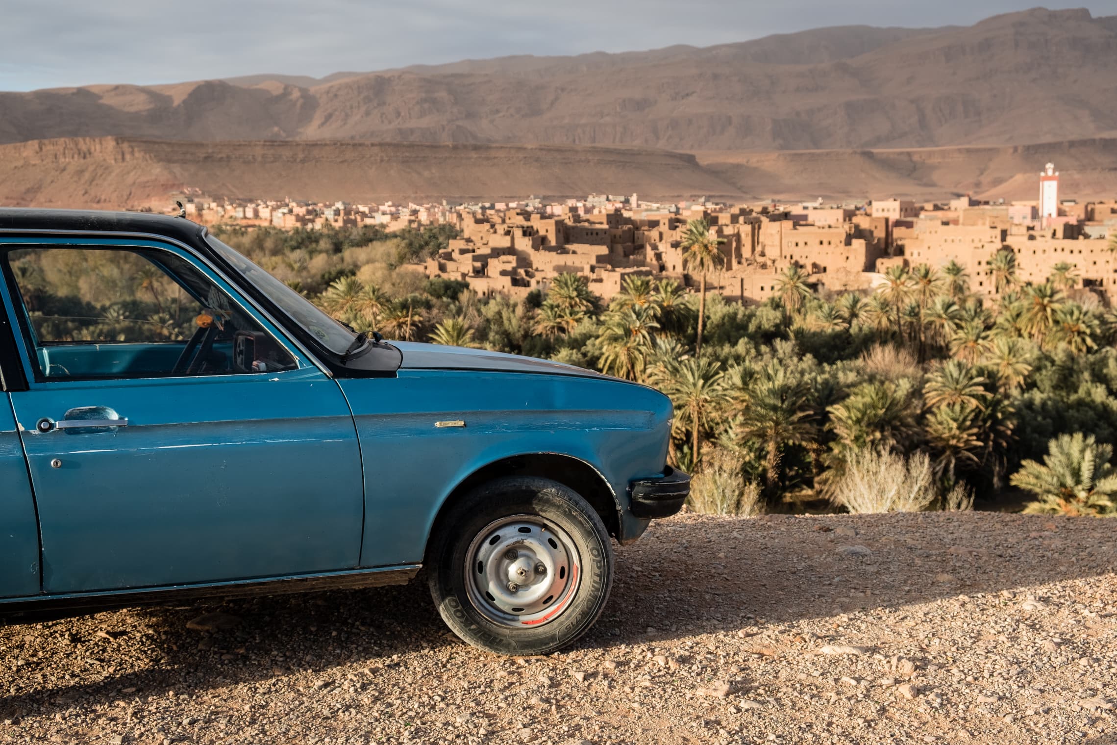 Old blue Mercedes looking over Tinghir and the palm groves