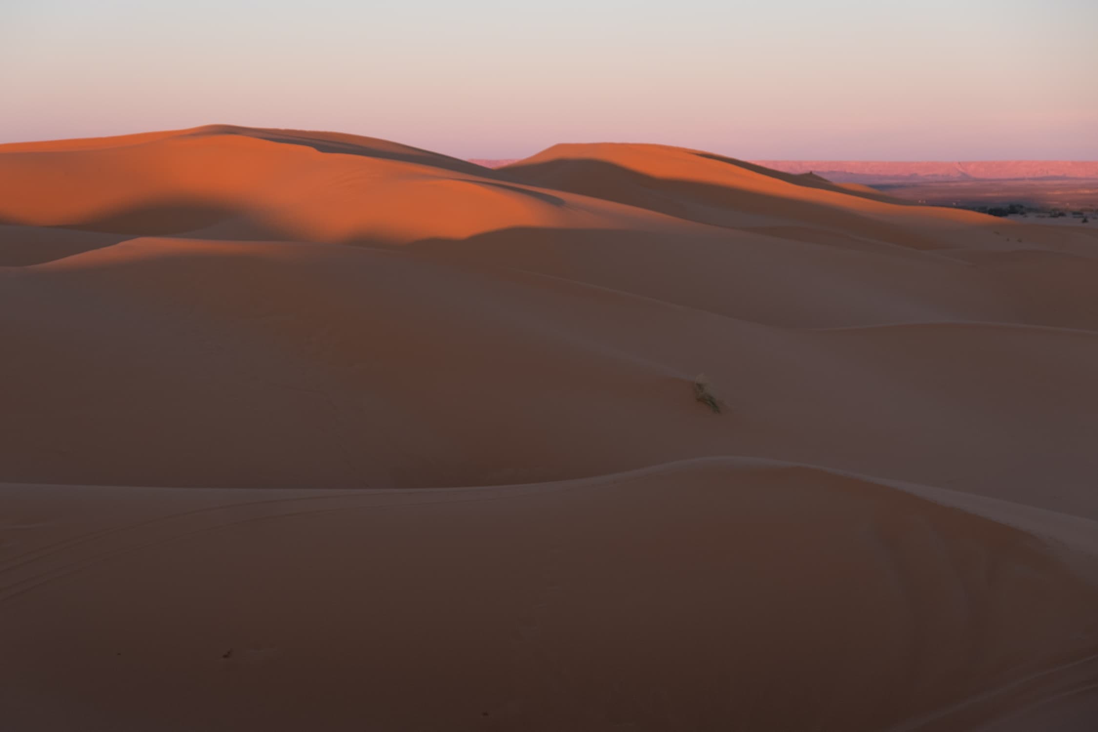 Sunset over layers of sand dunes
