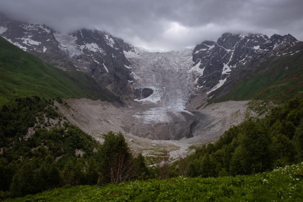 Adishi Glacier bowl with moody clouds shrouding the menacing peaks