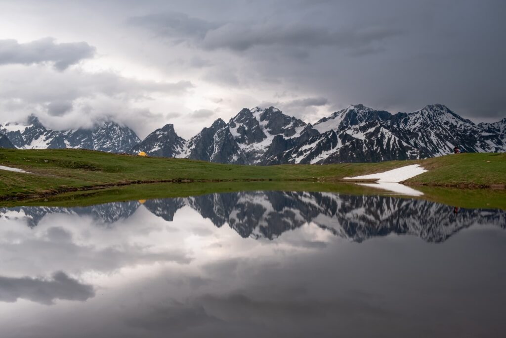 After the storm, our tent and mountains peaks reflecting in Koruldi lakes