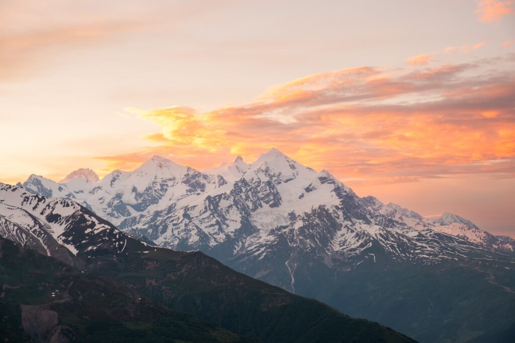 Candy floss clouds over the peak of mount Tetnuldi