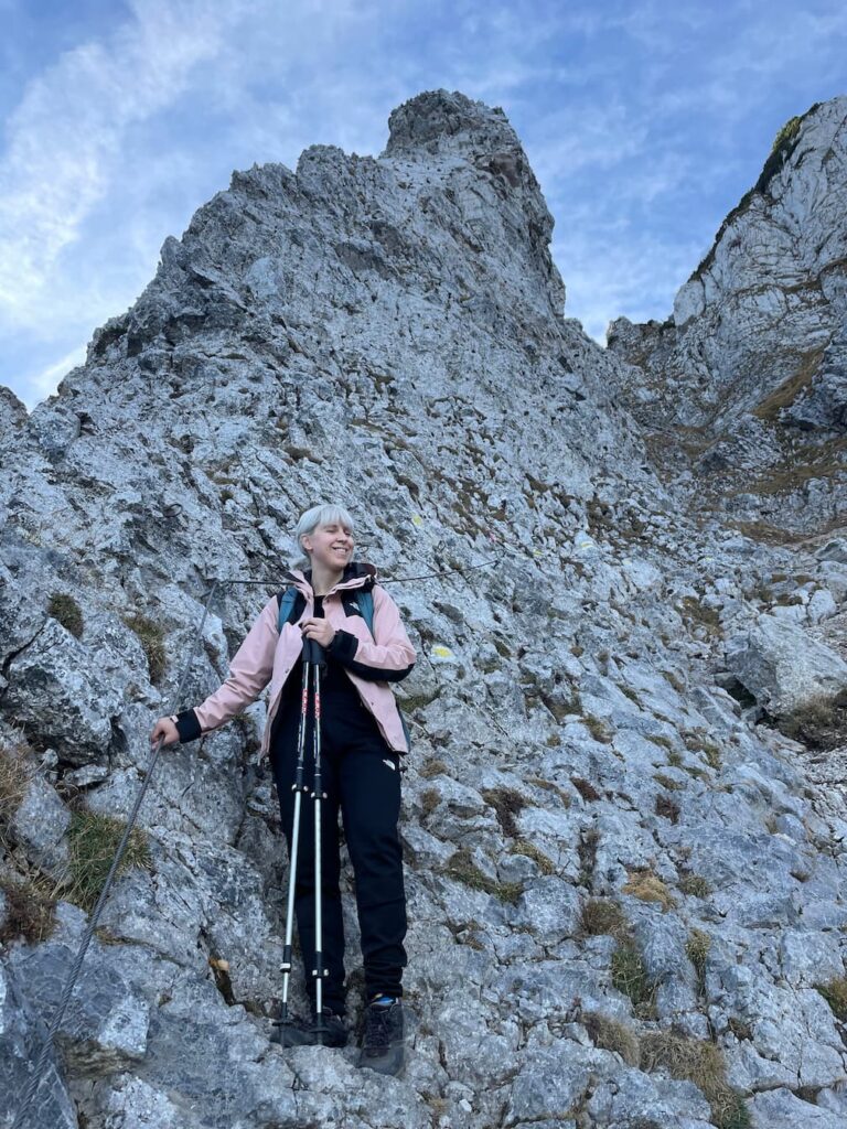 Caroline holding on to a metal cable on a steep section of the Fadensteig trail