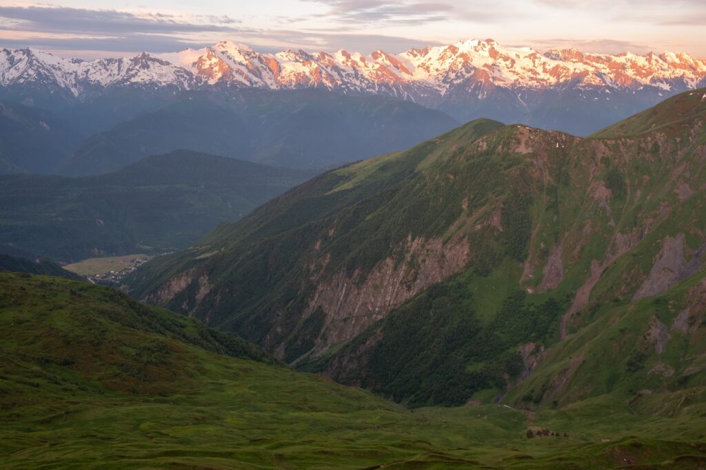 Early morning light over the snow capped Caucasus peaks looking towards Mestia, Koruldi lakes
