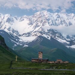 Lamaria church of Ushguli flanked by the snow covered Shkhara mountain