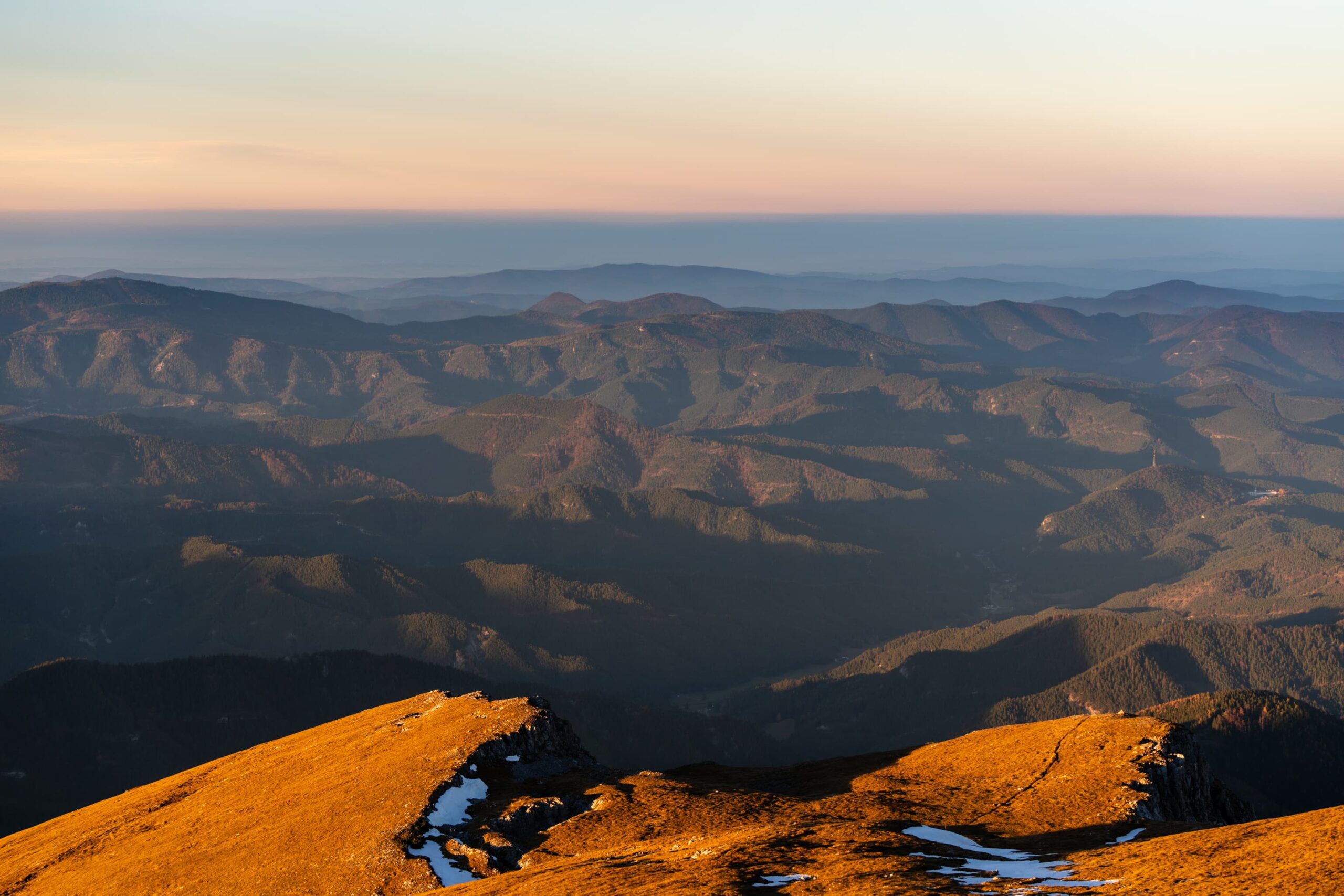 Light and shadows over the hills during sunset from Schneeberg