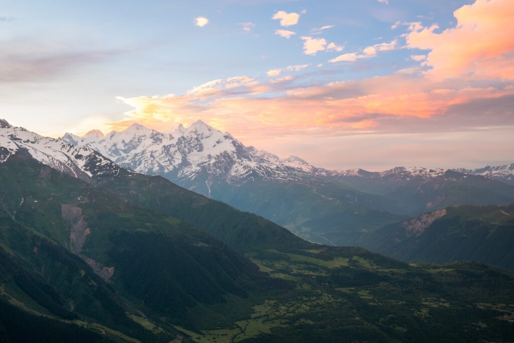 Beautiful pink sunset over a snowy mount Tetnuldi in Svaneti, Georgia from Koruldi Lakes