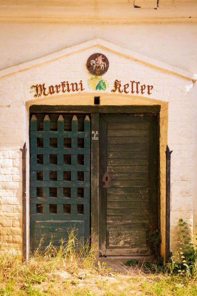 Old wooden door with painted inscription above in Pillichsdorf