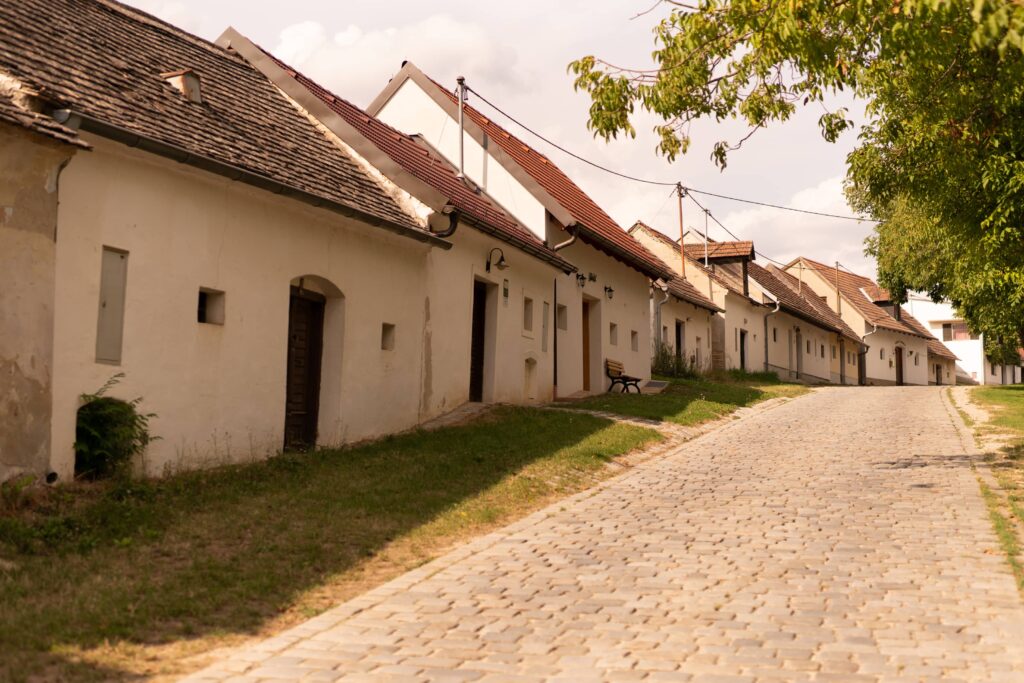 Row of white wine cellar buildings with cobbled street in Pillichsdorf