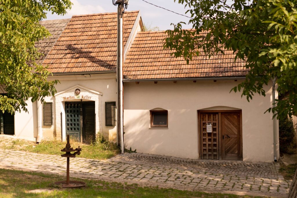 White wine cellar buildings with cobbled street in Pillichsdorf