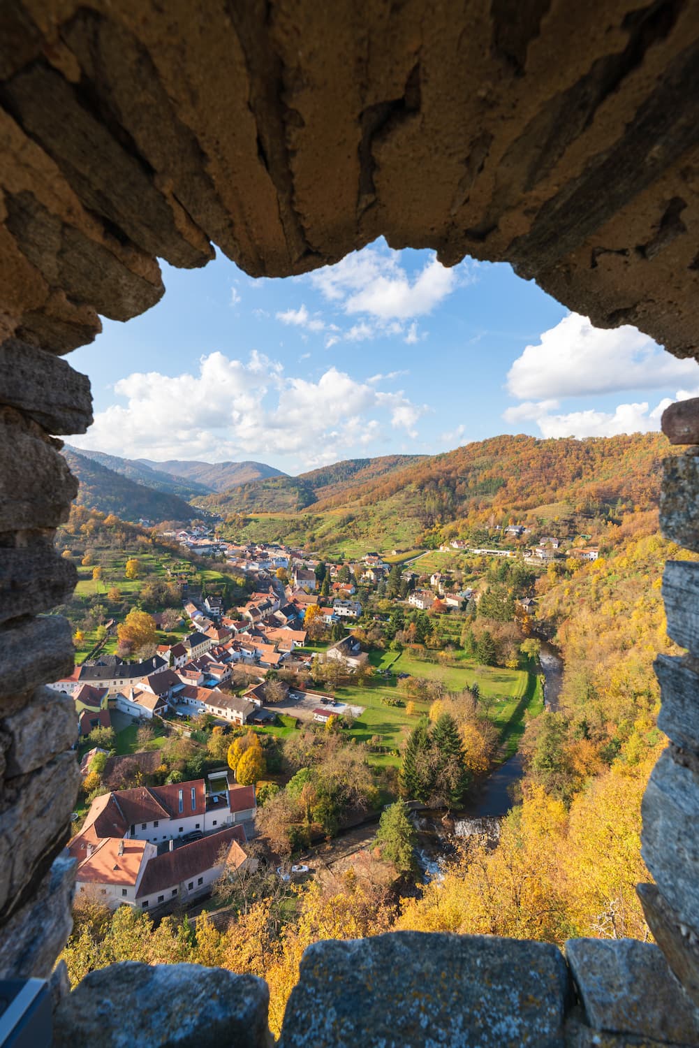 Looking over a sunny Kremstal (Krems valley) with vibrant autumn colours through a castle window